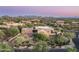 Picturesque aerial view of the home featuring a lush landscape, large lot, and stunning mountain views at 40039 N 107Th Pl, Scottsdale, AZ 85262