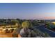Captivating backyard view featuring a refreshing pool, desert landscaping, and sparkling city lights in the distance at 40039 N 107Th Pl, Scottsdale, AZ 85262
