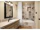 Bathroom featuring a white vanity, decorative mirror and a shower tub combo at 40039 N 107Th Pl, Scottsdale, AZ 85262