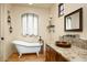 Stylish bathroom featuring a standalone tub, granite counters, vanity, and a rustic design at 40039 N 107Th Pl, Scottsdale, AZ 85262