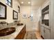 Spa-like bathroom featuring a double vanity with copper sinks and a tiled shower with an archway at 40039 N 107Th Pl, Scottsdale, AZ 85262