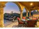 Inviting covered patio features lounge chairs, wicker seating, and charming sunset views of the surrounding desert landscape at 40039 N 107Th Pl, Scottsdale, AZ 85262
