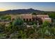 Desert home featuring a tiled roof, pergola, lush landscaping, covered porch, and mountain views at 40039 N 107Th Pl, Scottsdale, AZ 85262