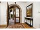 Elegant foyer with custom arched door and decorative rug leading into a charming, well-appointed home at 40039 N 107Th Pl, Scottsdale, AZ 85262