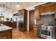Gourmet kitchen features custom cabinets, granite counters, tile backsplash, and stainless steel appliances at 40039 N 107Th Pl, Scottsdale, AZ 85262