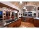 Spacious kitchen featuring an island with stone countertops, custom cabinets, and open to the living area at 40039 N 107Th Pl, Scottsdale, AZ 85262
