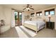 Bright main bedroom with fireplace, french doors leading to balcony, and comfortable king-size bed at 40039 N 107Th Pl, Scottsdale, AZ 85262