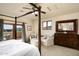 Main bedroom offering natural light with balcony access and a picturesque view of the surrounding landscape at 40039 N 107Th Pl, Scottsdale, AZ 85262