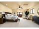 Comfortable main bedroom with wood accents, sitting area and access to balcony at 40039 N 107Th Pl, Scottsdale, AZ 85262