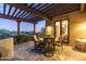 Cozy outdoor patio with pergola offers a comfortable seating area to enjoy the beautiful desert sunset and landscape at 40039 N 107Th Pl, Scottsdale, AZ 85262