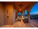 Inviting outdoor patio with comfortable seating, elegant archways, and serene views at 40039 N 107Th Pl, Scottsdale, AZ 85262
