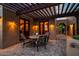 Outdoor patio with stone floors, wood pergola, and charming lighting creates a relaxing ambiance at 40039 N 107Th Pl, Scottsdale, AZ 85262