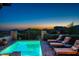 Scenic pool area with lounge chairs, spa, mature landscaping, and mountain views at 40039 N 107Th Pl, Scottsdale, AZ 85262