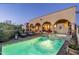 Sparkling swimming pool with lounge chairs and spa showcases the home's relaxing outdoor space and beautiful desert sunset at 40039 N 107Th Pl, Scottsdale, AZ 85262
