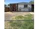 Charming single-story home with a red door and small porch, complemented by a spacious front yard at 4233 E Minton St, Phoenix, AZ 85042