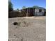 Cozy single-story home featuring a red door, small porch, and an expansive gravel front yard at 4233 E Minton St, Phoenix, AZ 85042