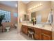 Bright bathroom with double sinks, wooden vanity, and decorative accents at 4281 S Tecoma Trl, Gold Canyon, AZ 85118
