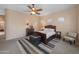 Comfortable bedroom with a ceiling fan, large windows, with carpet flooring and ample natural light at 4281 S Tecoma Trl, Gold Canyon, AZ 85118