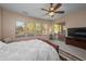 Serene bedroom with scenic views, large windows, ceiling fan, and access to a private patio or balcony at 4281 S Tecoma Trl, Gold Canyon, AZ 85118