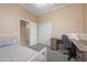 Bedroom with desk, ceiling fan, carpeted floors and ensuite bath access at 4281 S Tecoma Trl, Gold Canyon, AZ 85118