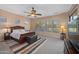 Cozy bedroom with ceiling fan, carpet flooring, with large windows offering ample natural light and view at 4281 S Tecoma Trl, Gold Canyon, AZ 85118