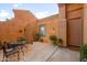 Private courtyard area with outdoor seating, lush plants and gate access at 4281 S Tecoma Trl, Gold Canyon, AZ 85118