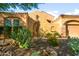 Inviting front entrance with mature desert landscaping, stone accents, and a cozy, covered porch at 4281 S Tecoma Trl, Gold Canyon, AZ 85118