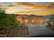 Home exterior showcasing desert landscaping, three-car garage, and warm exterior paint at 4281 S Tecoma Trl, Gold Canyon, AZ 85118
