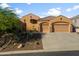 Beautiful front exterior showcases a well-maintained lawn and a three-car garage, great curb appeal at 4281 S Tecoma Trl, Gold Canyon, AZ 85118
