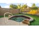 Relaxing backyard hot tub features artificial grass, a small wall, and privacy for a serene outdoor experience at 4281 S Tecoma Trl, Gold Canyon, AZ 85118