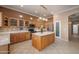 Spacious kitchen featuring an island, wooden cabinets, stainless steel appliances and tile backsplash at 4281 S Tecoma Trl, Gold Canyon, AZ 85118