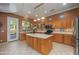 Gourmet kitchen featuring stainless appliances, custom cabinets, and a center island at 4281 S Tecoma Trl, Gold Canyon, AZ 85118