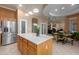Bright kitchen with stainless steel refrigerator, wooden island, and adjacent breakfast nook with a view at 4281 S Tecoma Trl, Gold Canyon, AZ 85118