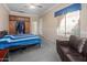 Bright main bedroom with a comfortable bed, built-in closet, and cozy lounge area by the window at 4281 S Tecoma Trl, Gold Canyon, AZ 85118