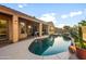 Stunning backyard oasis with a sparkling pool, waterfall, and inviting outdoor space at 4281 S Tecoma Trl, Gold Canyon, AZ 85118