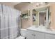 Bathroom with vanity, framed mirror, and shower-tub with curtain at 4434 E Wood St, Phoenix, AZ 85040