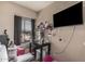 Bedroom with workspace, TV, and window with blinds at 4434 E Wood St, Phoenix, AZ 85040