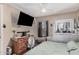 Bedroom with ceiling fan, hardwood floors, dresser, and TV at 4434 E Wood St, Phoenix, AZ 85040