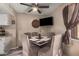 Inviting dining area with a mounted television, perfect for mealtime entertainment at 4434 E Wood St, Phoenix, AZ 85040