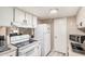 Functional kitchen with white cabinetry, appliances, and laminate countertops at 4434 E Wood St, Phoenix, AZ 85040