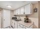 Cozy kitchen with white cabinets, laminate countertops, and stainless sink at 4434 E Wood St, Phoenix, AZ 85040