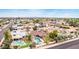 Aerial neighborhood shot featuring a backyard pool and a covered patio with mature, flowering landscaping at 4510 W North Ln, Glendale, AZ 85302