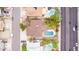 Aerial neighborhood shot showcasing a backyard with a pool, covered patio and mature trees surrounded by residences at 4510 W North Ln, Glendale, AZ 85302
