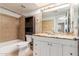 Bathroom featuring a vanity, toilet, shower and bath at 4510 W North Ln, Glendale, AZ 85302