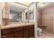 Bathroom featuring tiled vanity countertop, large mirror and walk-in shower at 4510 W North Ln, Glendale, AZ 85302