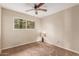 Cozy bedroom features a ceiling fan, and a bright window at 4510 W North Ln, Glendale, AZ 85302