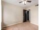 Bedroom featuring carpet, fan, and hallway access at 4510 W North Ln, Glendale, AZ 85302