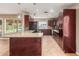Modern kitchen with granite countertops, stainless steel appliances, and sleek dark wood cabinetry at 4510 W North Ln, Glendale, AZ 85302