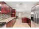 Contemporary kitchen with granite counters, stainless steel appliances, and dark wood cabinets at 4510 W North Ln, Glendale, AZ 85302