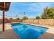 A sparkling blue pool is surrounded by a concrete deck and block wall for privacy at 4510 W North Ln, Glendale, AZ 85302